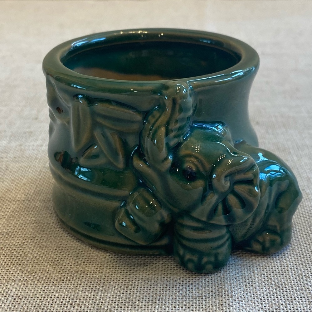 Ceramic green elephant planter with trunk up pottery.